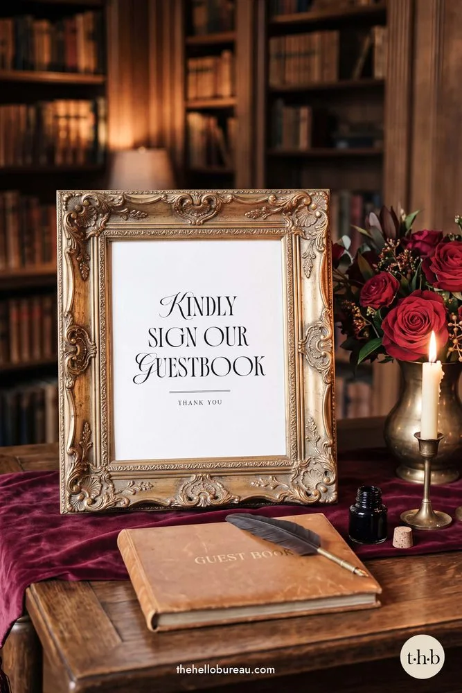Old money kindly sign our guestbook sign in an ornate gold frame with red roses, a candle and a leather guestbook