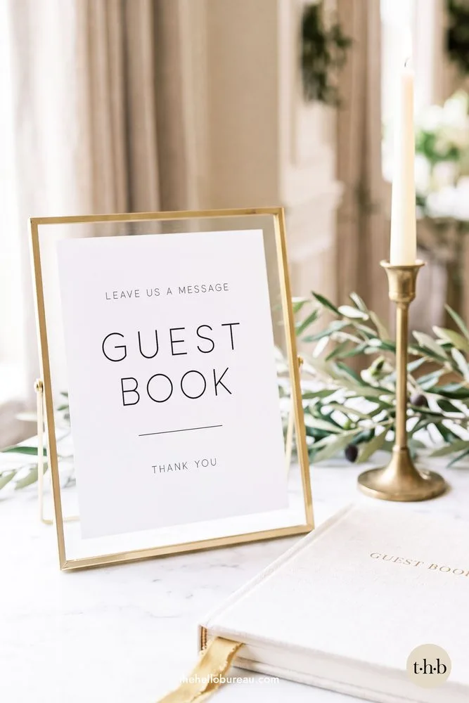 Minimal leave us a message guestbook sign in a gold frame with olive branches and a taper candle