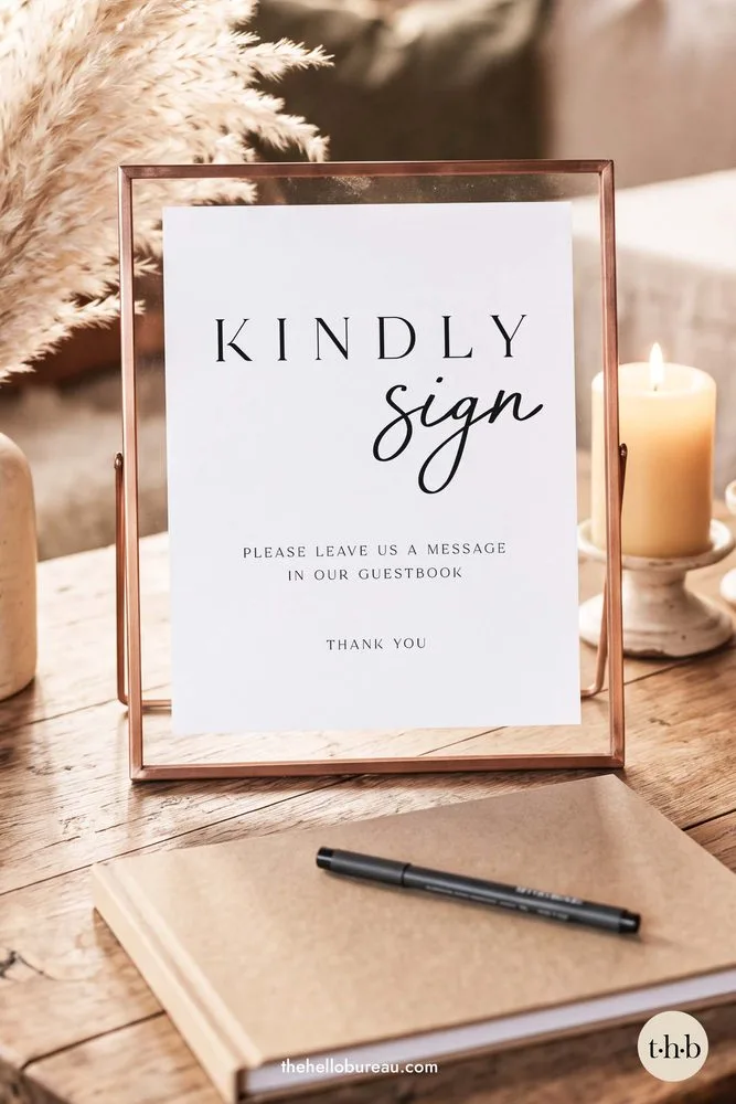 Modern kindly sign guestbook sign in a copper frame with a candle, pampas grass and a kraft guestbook