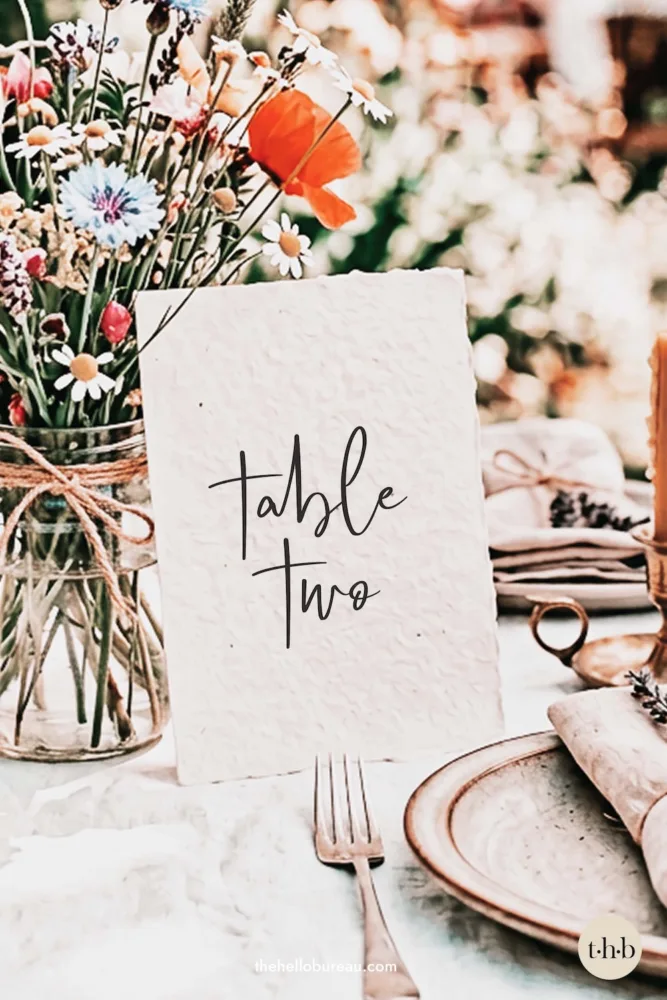 Whimsical free printable table number featuring "table two" in a cute, handwritten script font. A simple and charming DIY template for a relaxed reception.