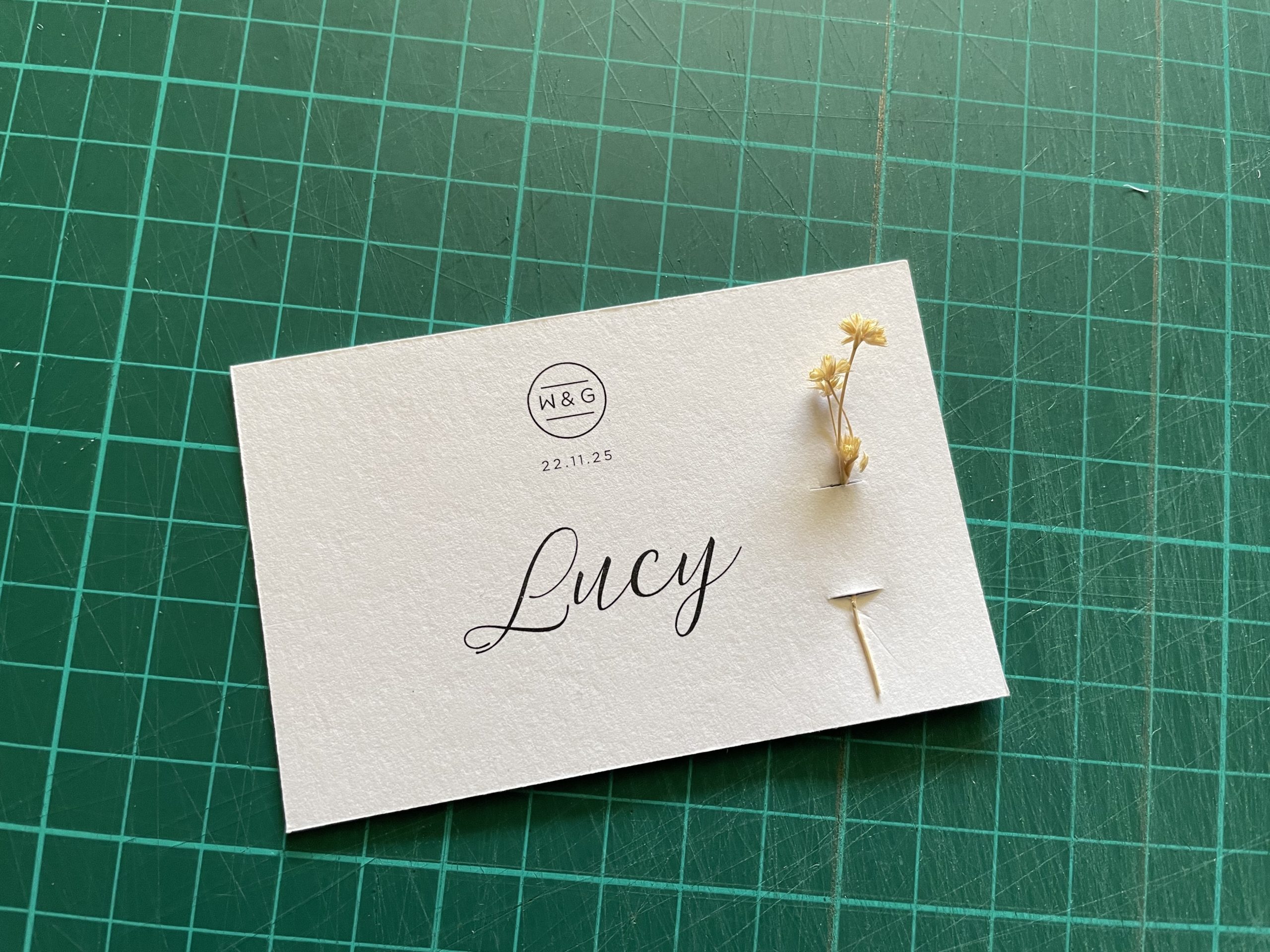DIY place card with a flower stem on the side