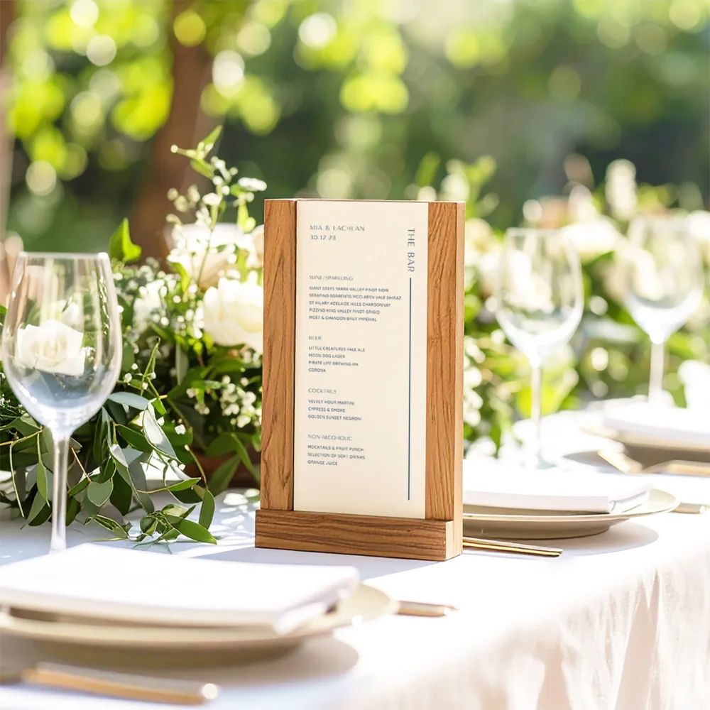 Coastal-style Laguna wedding bar menu displayed in a tall timber stand. Features a clean, airy layout with blue accents, perfect for an outdoor Australian summer wedding or beachside reception.