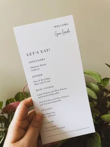 A hand holding a menu