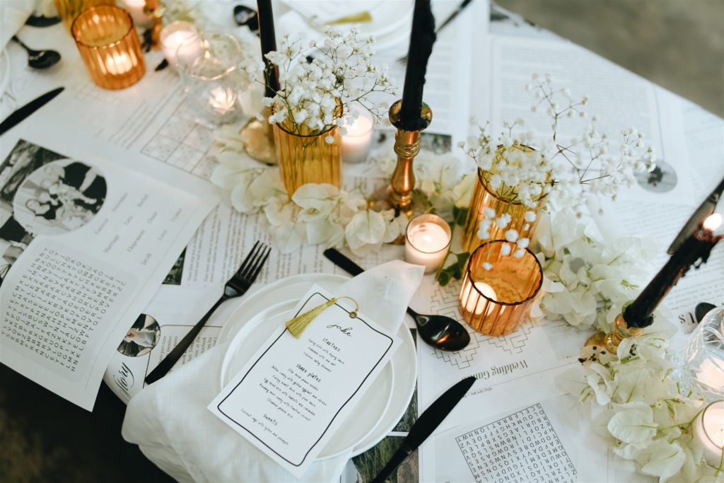 Black and yellow decor on a table covered in newspaper for a baby shower. Location: Perth.