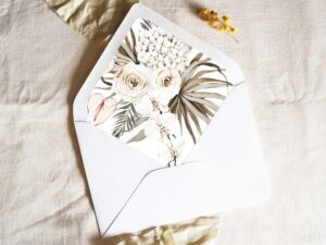 White envelope with a printed liner showing illustrated bohemian florals.