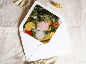 White envelope with a printed liner showing a painted floral bouquet.