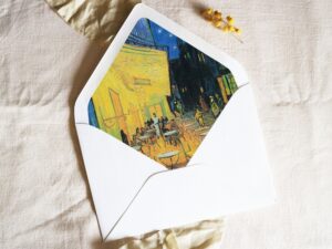 White envelope with a printed liner showing a painted night cafe scene.