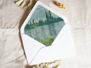 White envelope with a printed liner showing a painted countryside landscape.