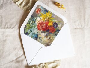 White envelope with a printed liner showing a painted floral bouquet.