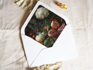 White envelope with a printed liner showing a painted floral bouquet.