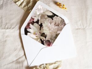 White envelope with a printed liner showing a painted floral bouquet.