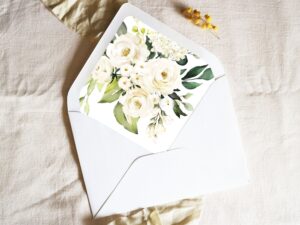 White envelope with a printed liner showing a painted floral bouquet.