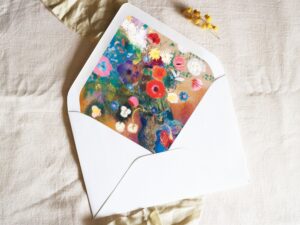 White envelope with a printed liner showing a painted floral bouquet.