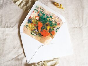 White envelope with a printed liner showing a painted floral bouquet.