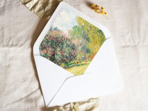 White envelope with a printed liner showing painted forest scene.