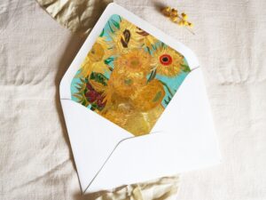 White envelope with a printed liner showing a painting of sunflowers.