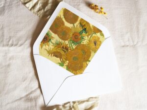 White envelope with a printed liner showing a painting of sunflowers.