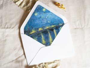 White envelope with a printed liner showing a painted starry night scene.