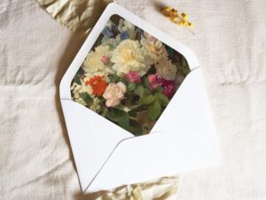 White envelope with a printed liner showing a painted floral bouquet.