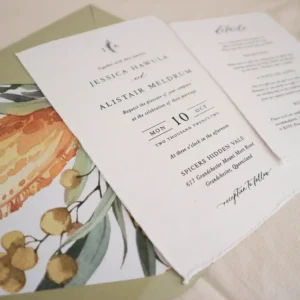 A wedding invitation with a sage green envelope