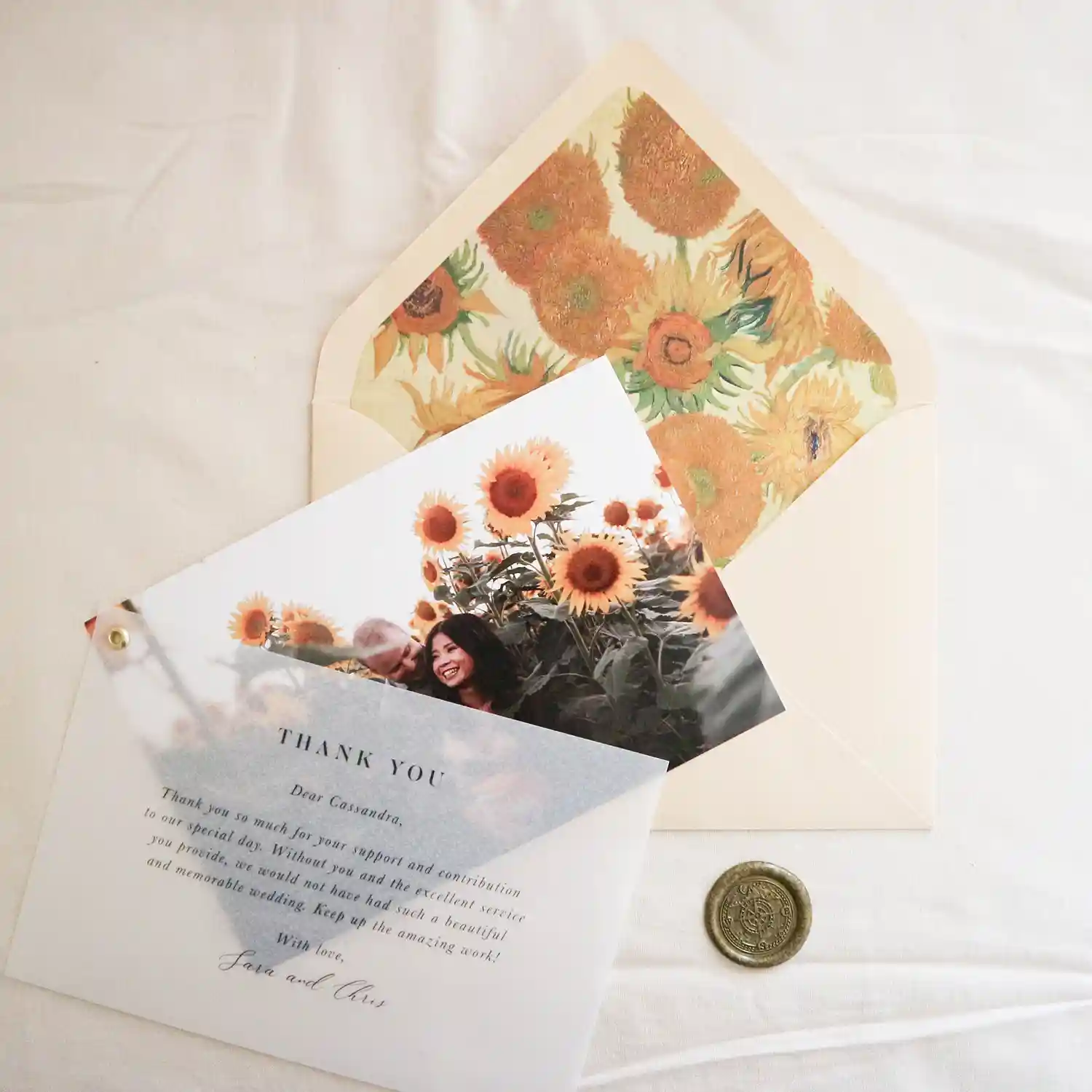 A thank you card with a photo, envelope and a bronze wax seal
