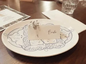 A plate with a flower place card on it