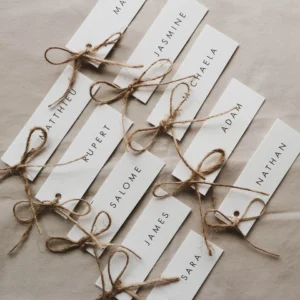 A group of white long place cards tied with twine