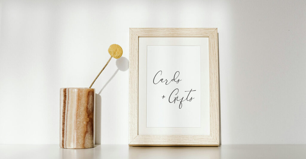 A wooden photo frame displaying a cards and gifts sign