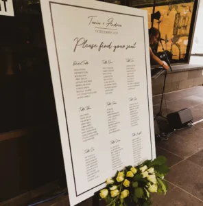 A wedding seating chart sign on an easel