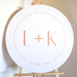 A round wedding welcome sign on an easel