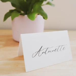 A folded place card on a wooden table