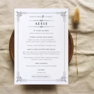 An Art Deco wedding menu on a wooden plate