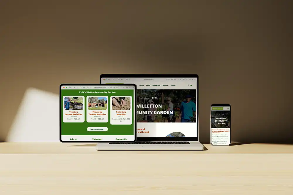 A tablet, laptop and mobile phone on a table featuring the Willetton Community Garden website.