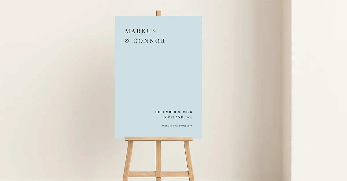 A welcome sign with a blue background colour on an easel in a white room.