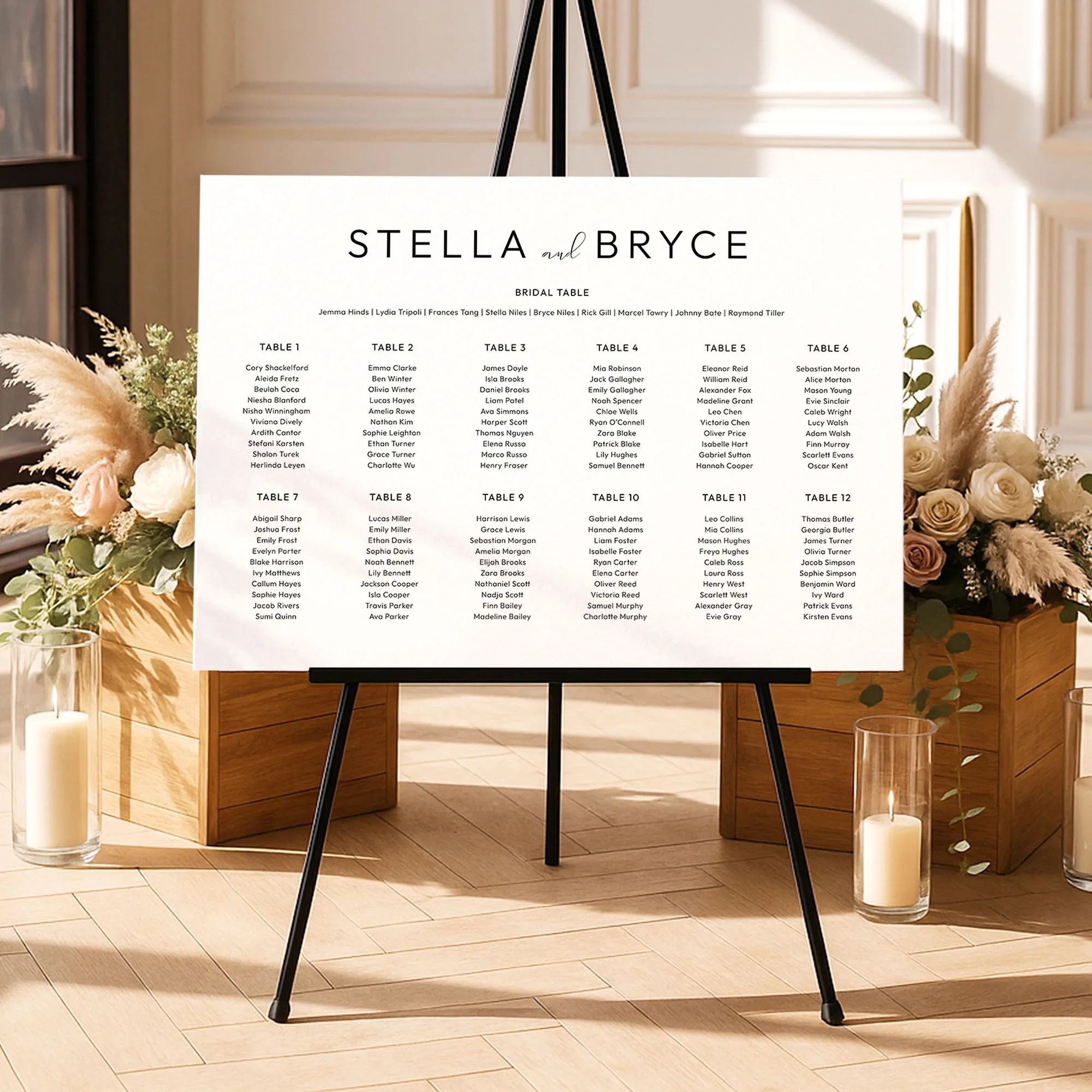 12-table seating chart for a wedding on an easel with decorative flowers and candles in a room.