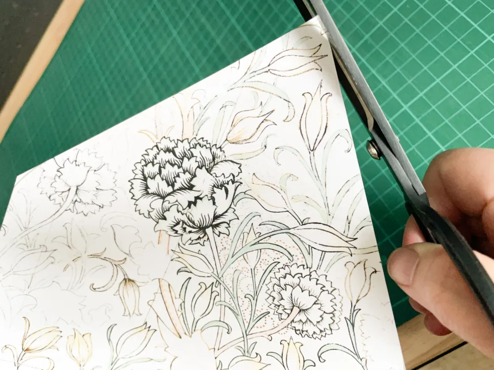 Cutting curved corners of envelope liner with scissors