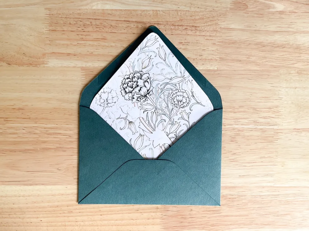 Wild Tulip envelope liner placed inside green envelope before trimming