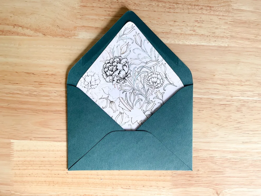 Trimmed envelope liner fitted inside green envelope