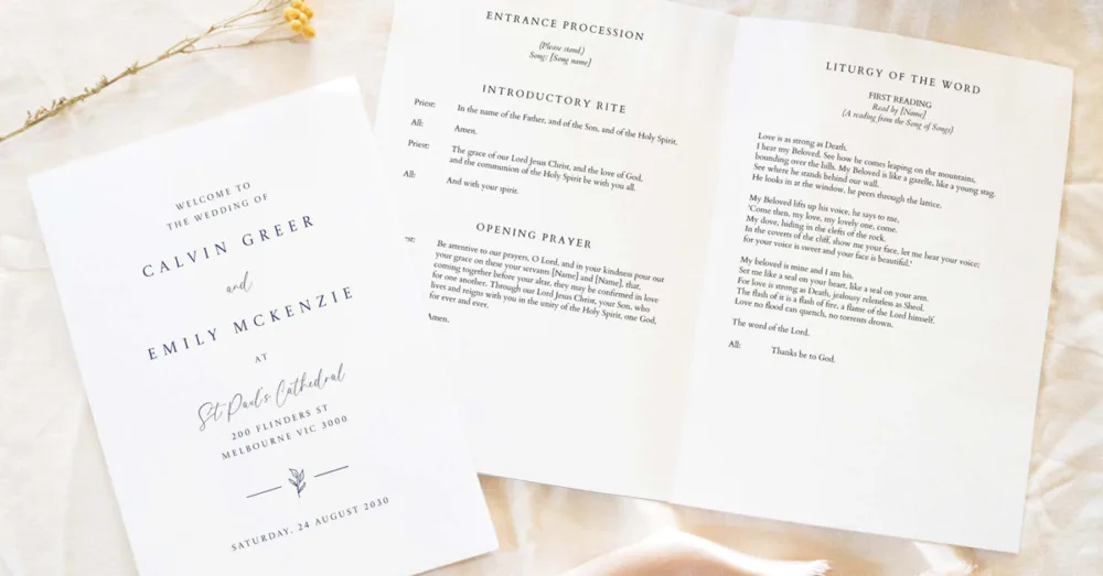 Open Catholic wedding ceremony booklet displayed on a wooden table, showing printed A5 layout with liturgical wording for the Entrance Procession and First Reading.