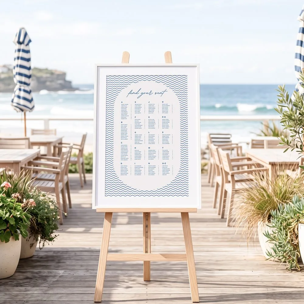 A framed alphabetical seating chart in a beach cafe setting.