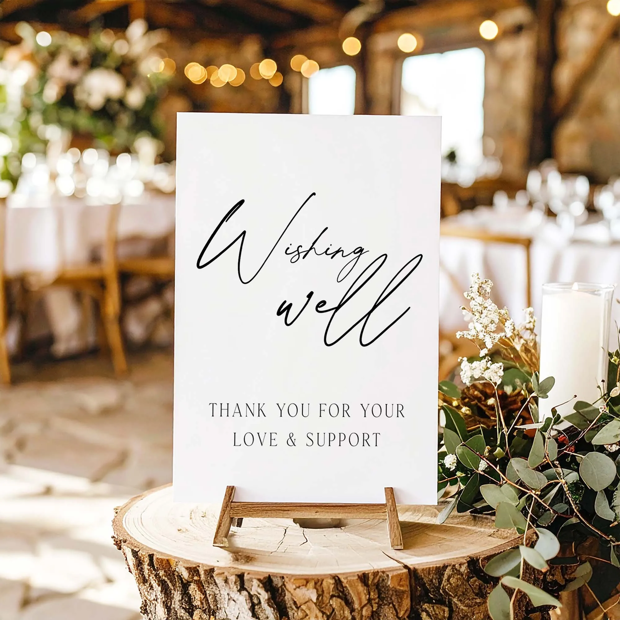 A printable wishing well sign with modern script typography on a wooden table easel.