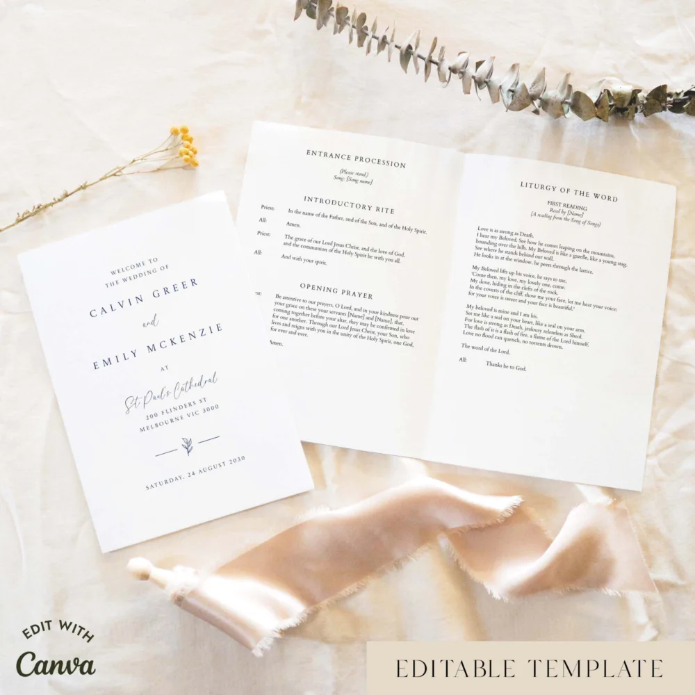 Elegant A5 Catholic wedding program shown open with the cover beside it, styled on light fabric with dried florals and a soft ribbon.