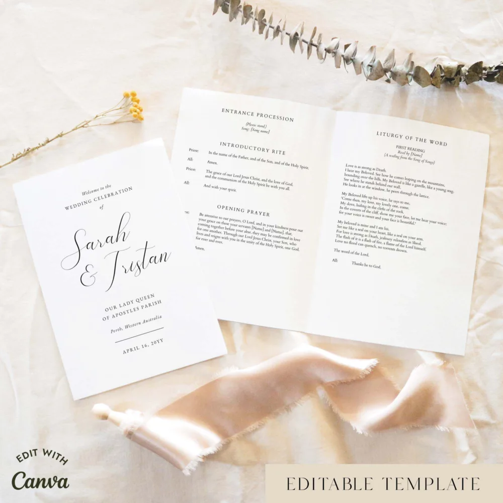 Elegant A5 Catholic wedding program shown open with the cover beside it, styled on light fabric with dried florals and a soft ribbon.