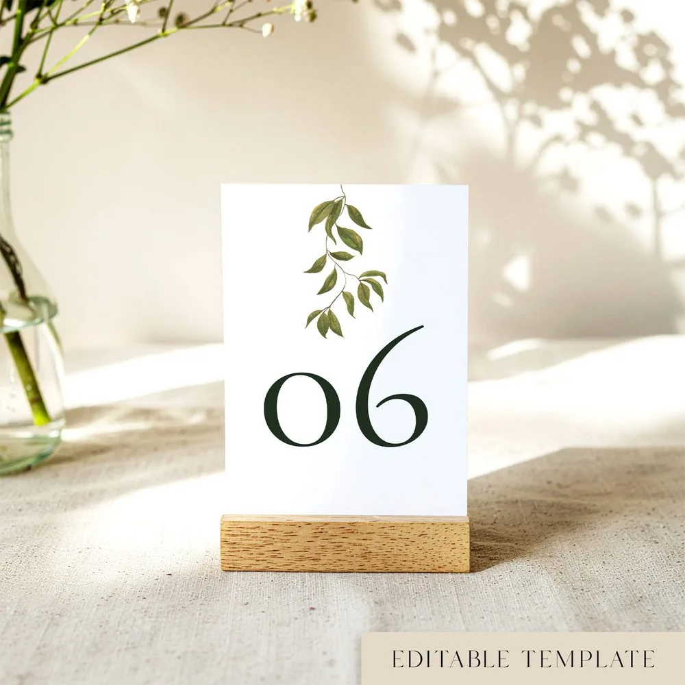 Printable wedding table number template in a wood block stand, numeral 06 under hand-painted greenery