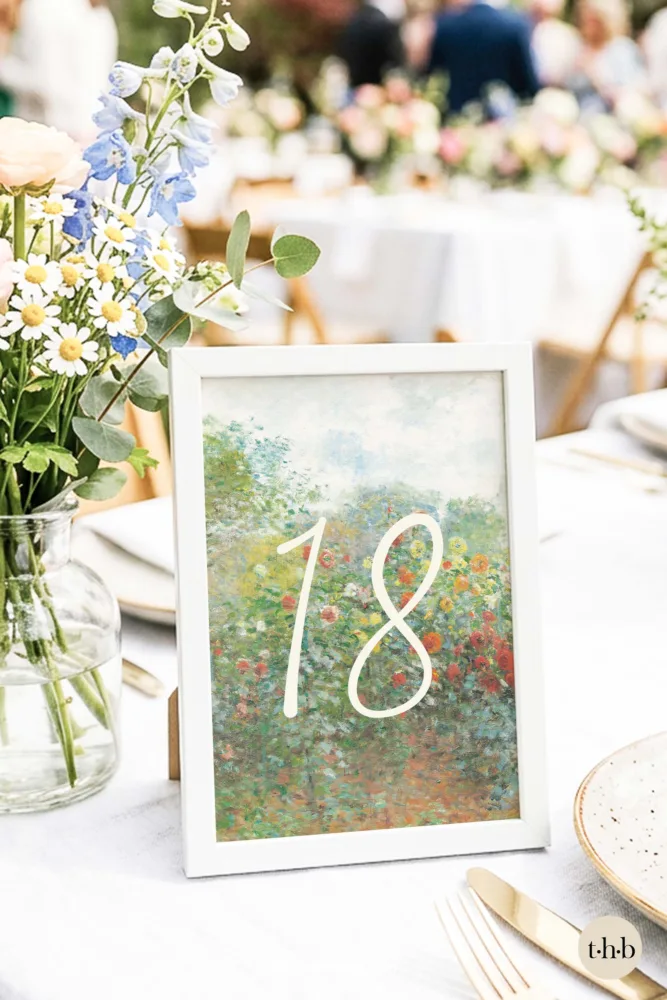 Free printable Monet table number in a white frame, styled on a spring garden wedding table