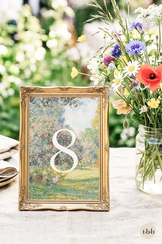 Monet's Parc Monceau fine art table number in a gold frame on a spring garden wedding table with wildflowers
