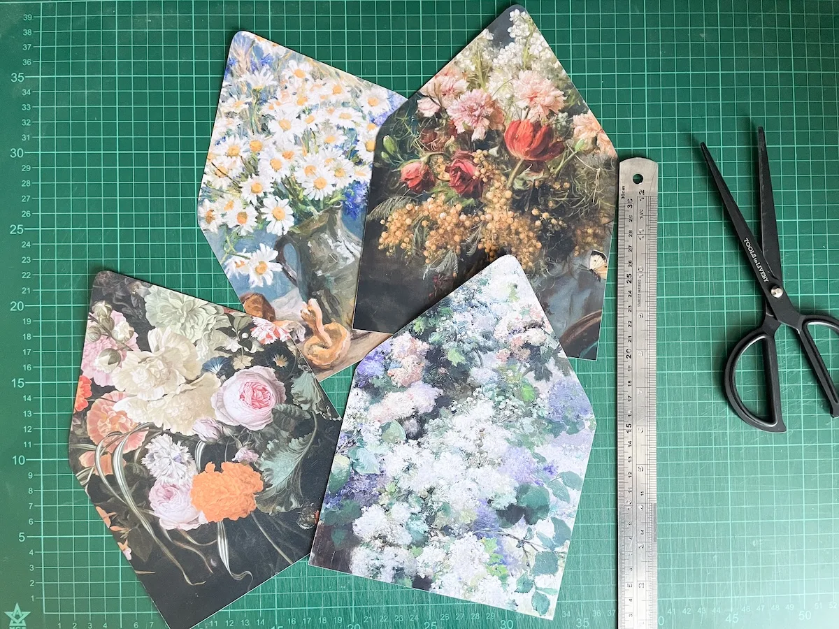 Four printed and cut 5x7 (A7) envelope liners on a cutting mat beside a ruler and scissors.